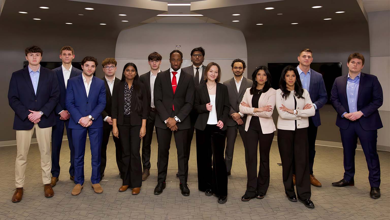 A diverse group of young professionals dressed in business attire, smiling