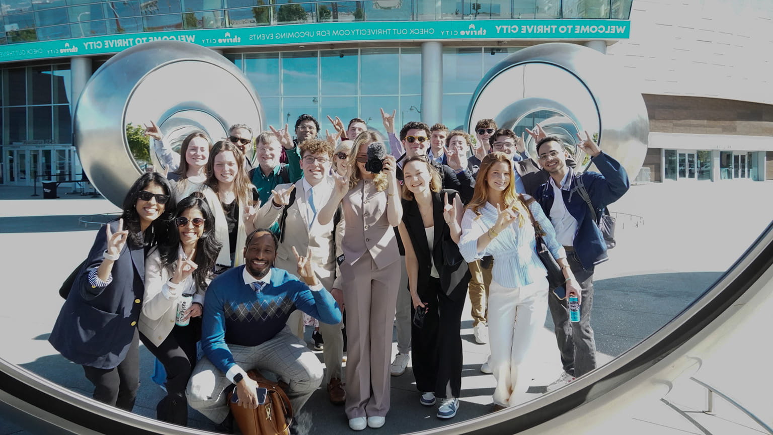 Students posing and taking a photo in the reflection of the famous outdoor Seeing Spheres exhibit in Silicon Valley.