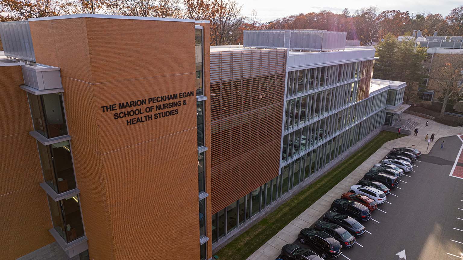 A brick building with a spacious parking lot in front, showcasing a clear view of the structure and surrounding area.