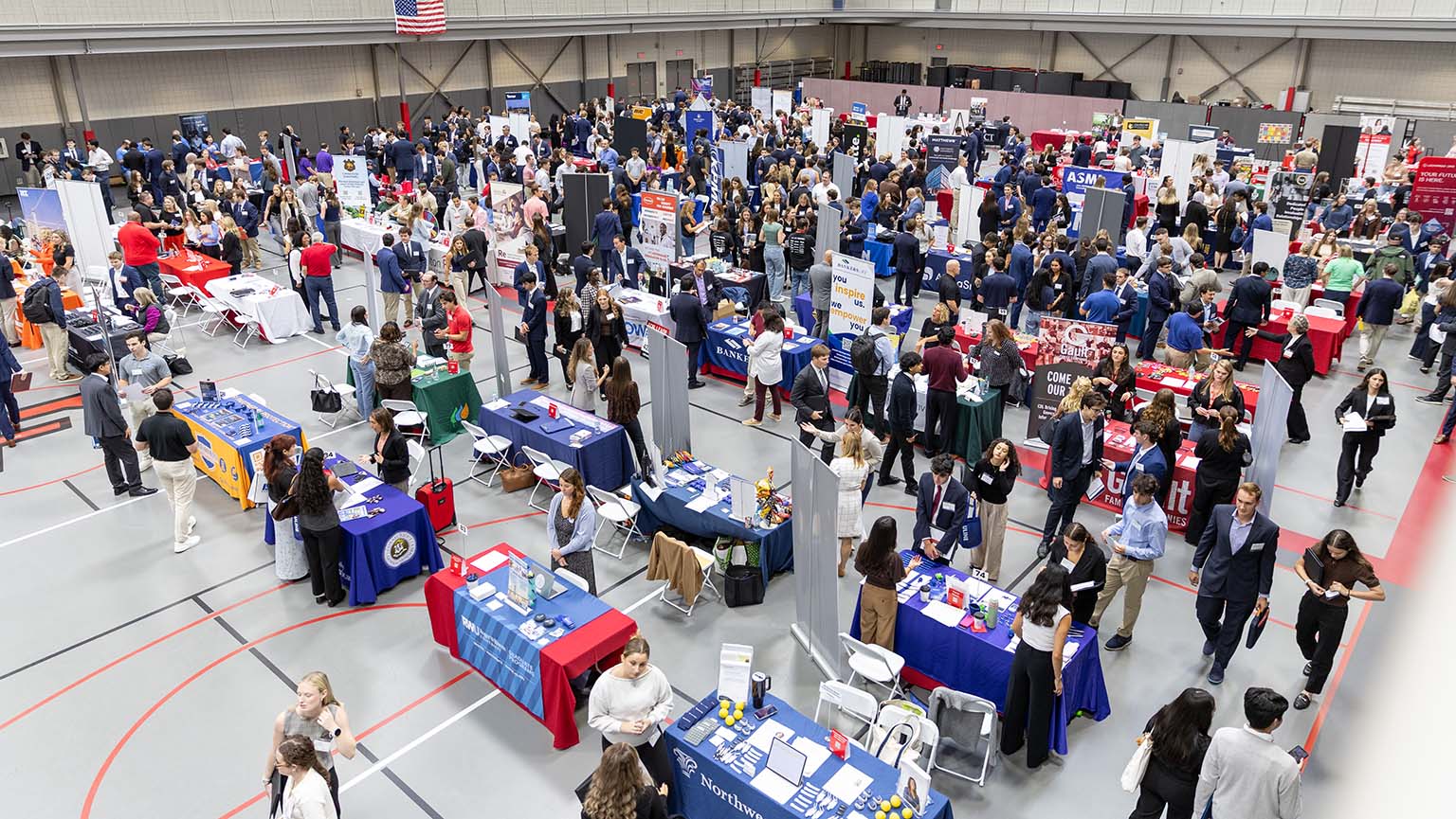 Attendees and recruiters engage in discussions at a lively job fair, showcasing various career opportunities.