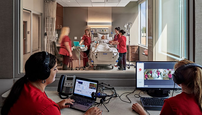 Realistic render of Nursing students in a projected layout of a new simulation lab in the Fairfield Egan building.