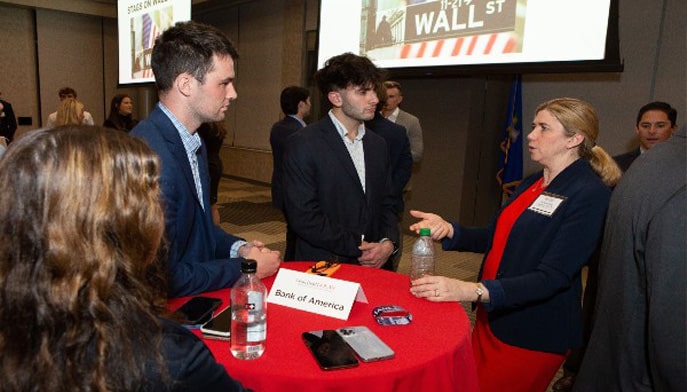 Students networking with a professional from Bank of America 