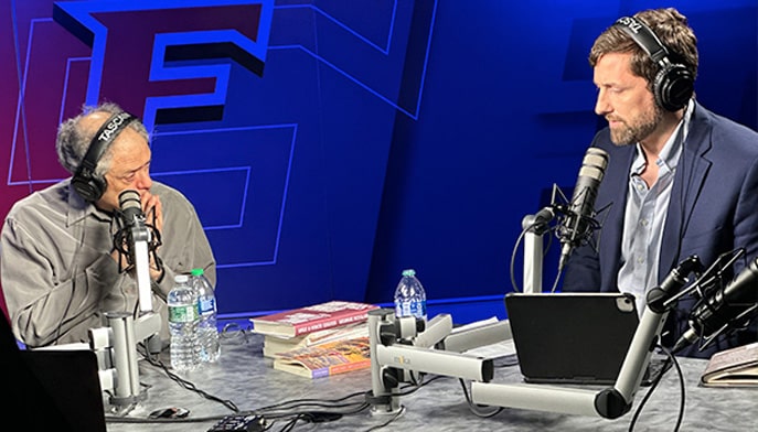 Phil Klay and George Scialabba sit at a table in the Media Center during podcast.