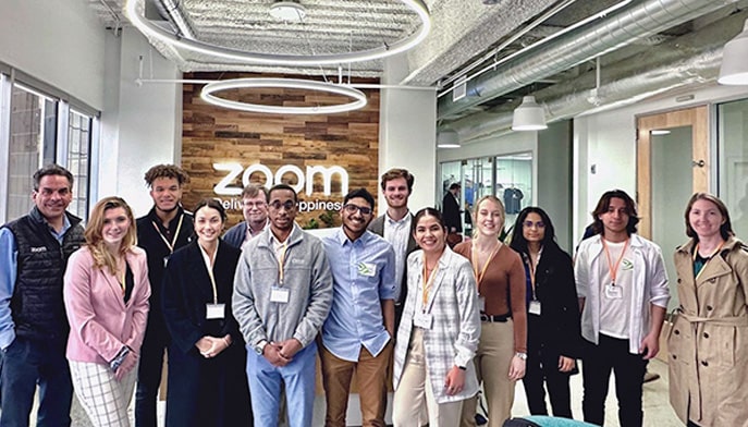 Group photo of students on Silicon Valley immersion trip inside Zoom headquarters.