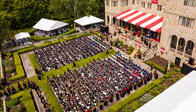Overhead drone shot of Fairfield University's 73rd Commencement exercises, held on the lush, sun-drenched Bellarmine Lawn.