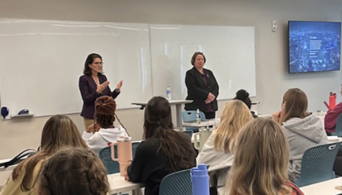 Sarah Keitt and Cristin McCarthy Vahey in classroom with students