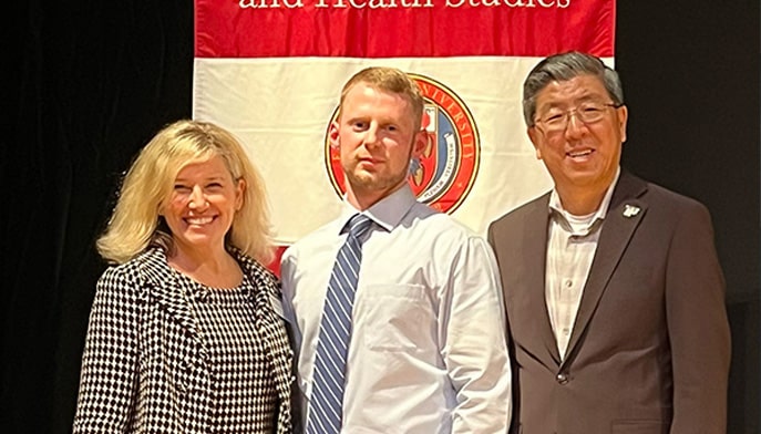 MSN/MBA graduate John Belden with Egan School Dean Meredith Kazer, PhD, APRN, FAAN, and Dolan School Dean Zhan Li, DBA.