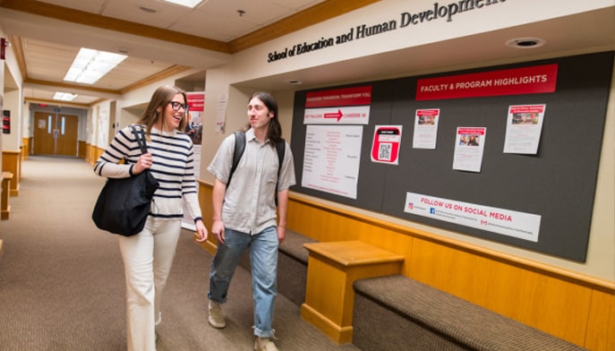 Two people walking through the SEHD