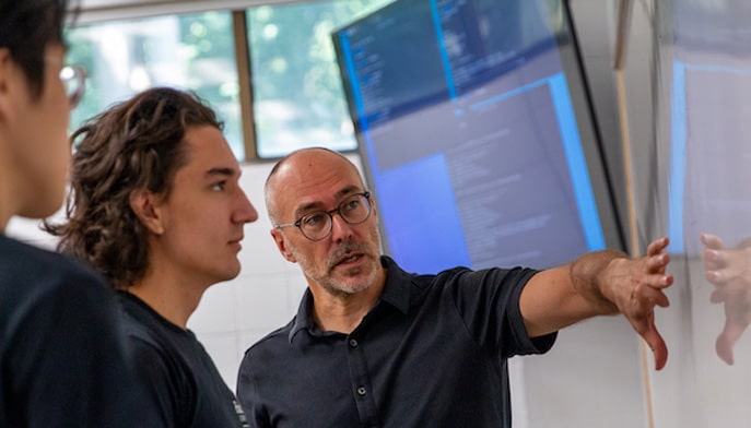 Students from the School of Engineering and Computing in front of white board.