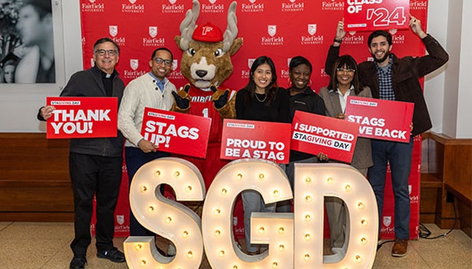Students posing in front of StaGiving Day sign