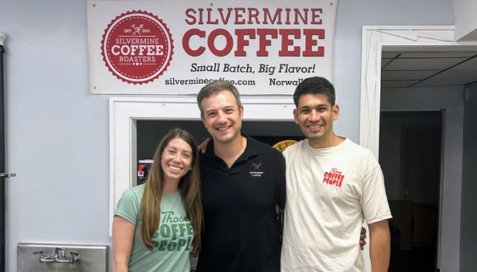 Two representatives from Those Coffee People of Medellin, Colombia alongside a Silvermine Coffee Roaster employee.