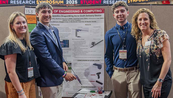 Image of engineering students posing at the annual student research symposium