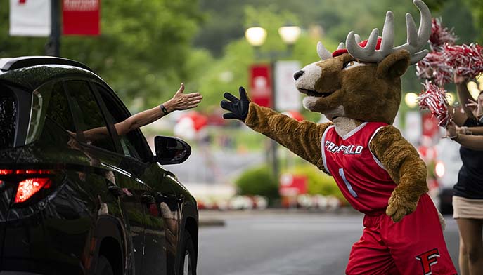 Image of Lucas the Stag cheerfully waving at people