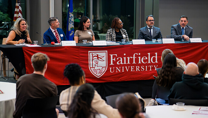 A panel discussion featuring Fairfield University faculty and others, highlighting their perspectives and collaborative dialogue.