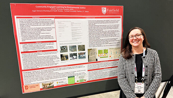  A woman stands beside a poster board displaying informational content. 