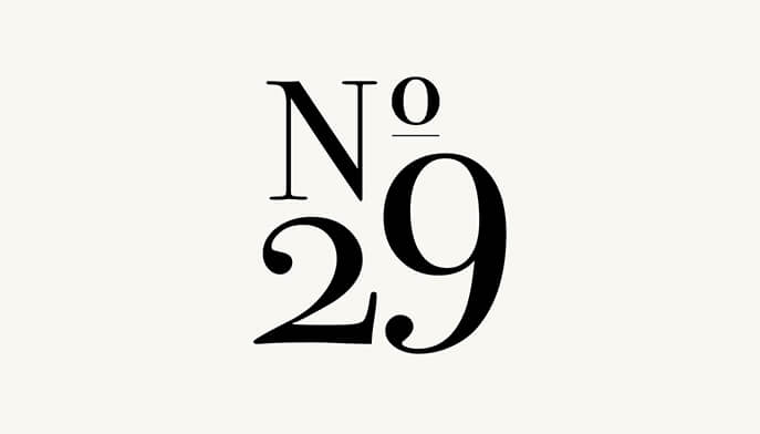 The numeral 29 illustrated in a simple black and light beige design.  