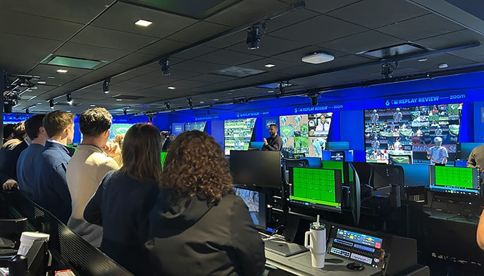 Fairfield students in a media room filled with monitors and screens.