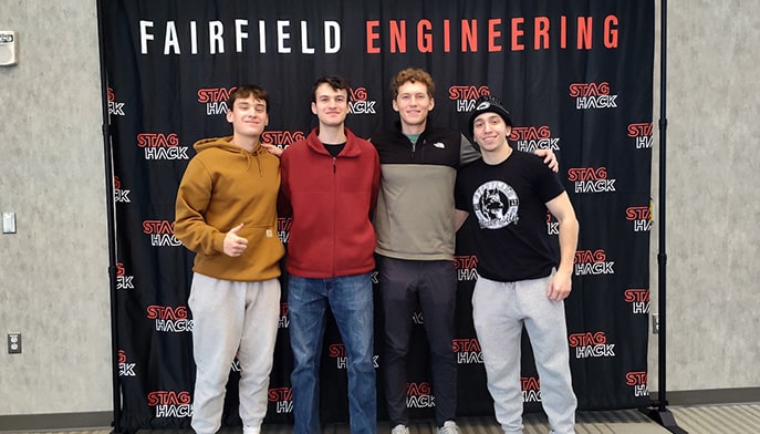 Fairfield Staghack team posing in front of a 'STAGHACK' banner.