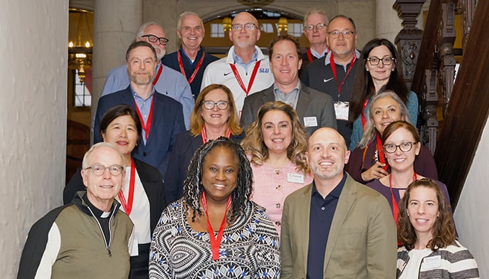 Attendees of this year's AJCU deans conference (held on Fairfield University's campus) smiling and posing as a group.