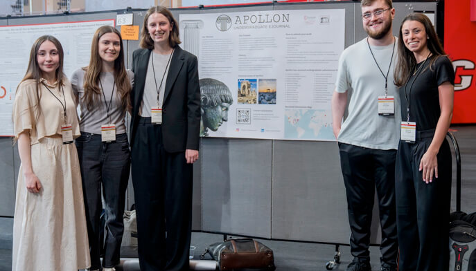 Students at the research symposium standing in front of their poster. 