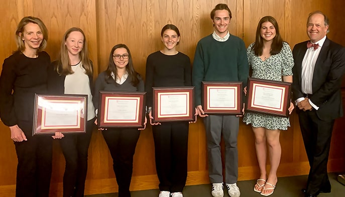 Winners (and an honorary mention) of this year's Library Research Prize posing together with their framed certificates.