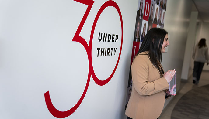 Fairfield alumna receiving a resin plaque commemorating her recognition as a Dolan 30 Under 30 awardee.