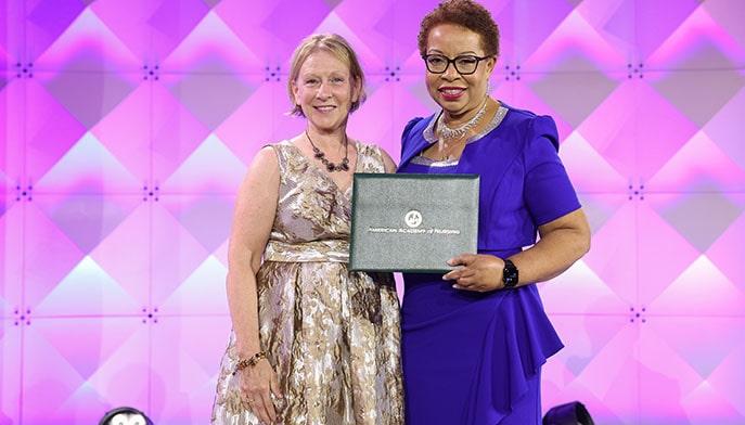 Fairfield professor on stage during her induction into the American Academy of Nursing.