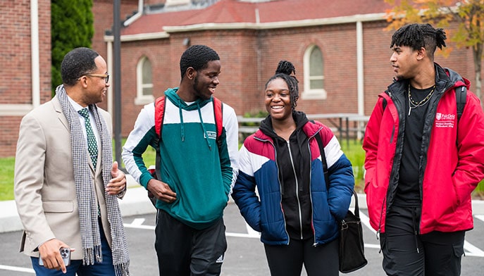 Fairfield Bellarmine assisstant dean of student success with Bellarmine graduate and current students.