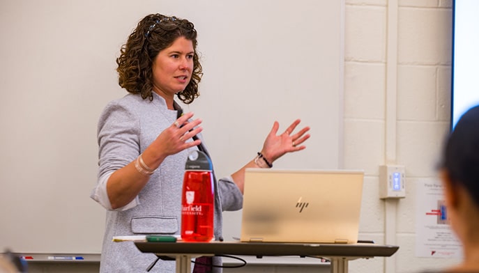 Industrial/Organizational psychology professor giving a lecture in a classroom.