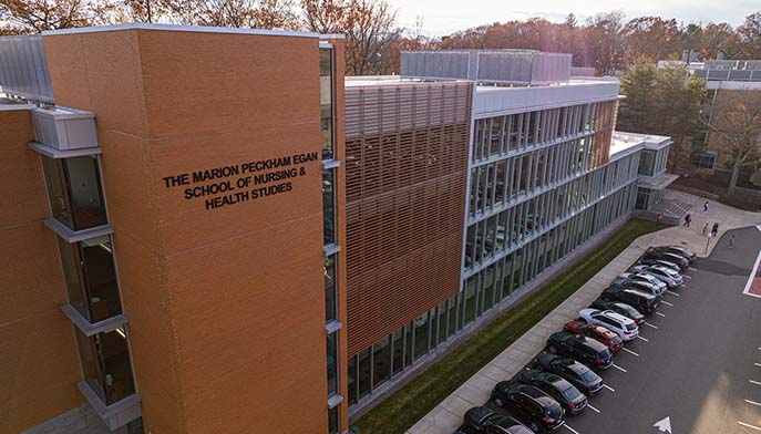 A brick building with a spacious parking lot in front, showcasing a clear view of the structure and surrounding area.