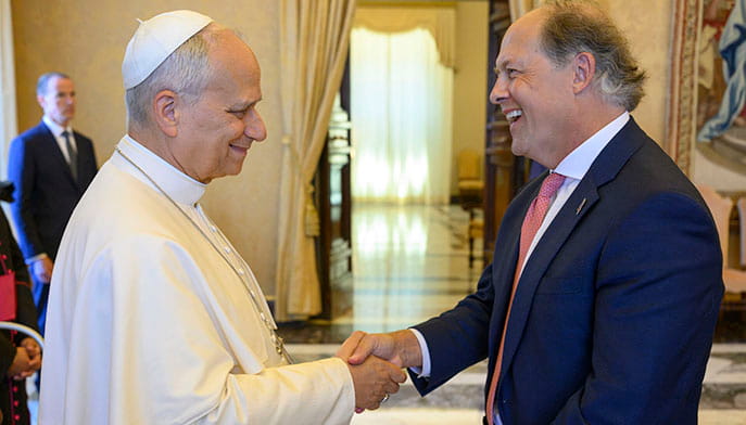 Fairfield University President shaking hands with the current Pope, dressed in his white papal robe, following the private delegation meeting with the AJCU.