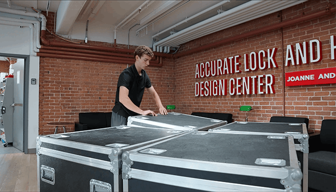 Fairfield Engineering student closing up heavy-duty music storage cases.