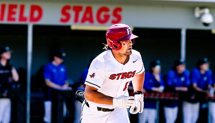 Fairfield Baseball student-athlete Matthew Bucciero ’26, reigning MAAC Player of the Year, in a white uniform jogging to first base.