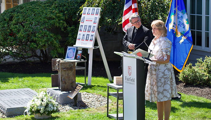Asst. vice president of alumni relations (Janet Canepa) and Fr. Paul O'Rourke read the names of the deceased at Fairfield's 9/11 memorial.