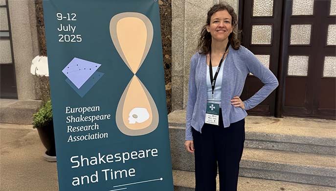 Image of Dr. Shannon Kelley posing in front of a conference banner.
