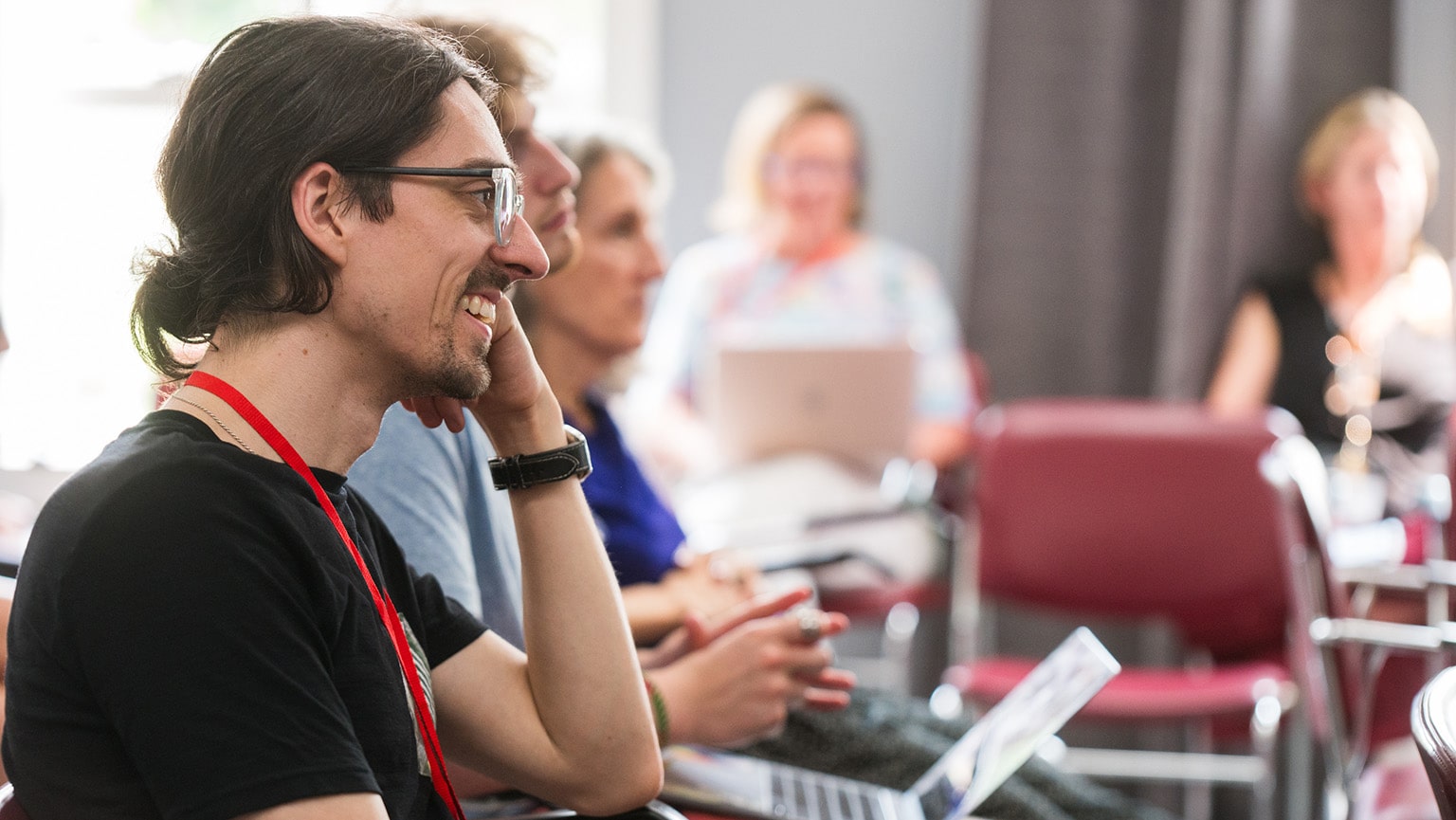 Creative writing MFA candidate engaging in a group workshop discussion during the residency retreat on Ender's Island.