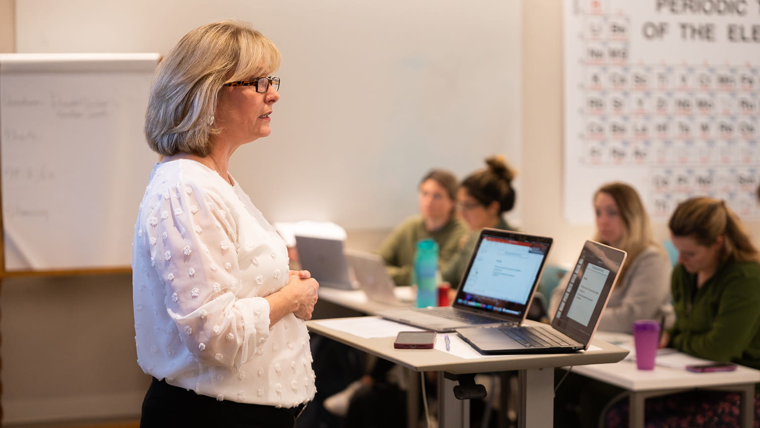 Master of Public Health professor giving a lecture in a small, intimate classroom.