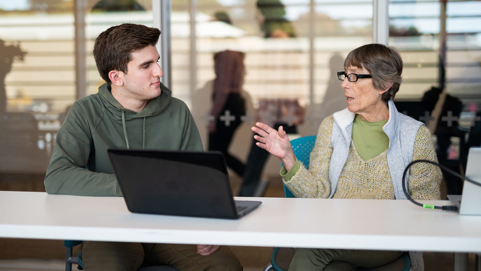 Master of Public Health professor and graduate candidate having a discussion in a classroom.