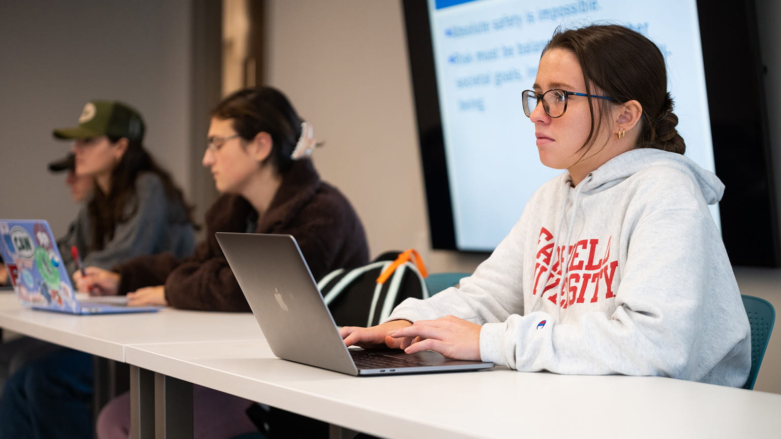 Master of Public Health students taking diligent notes during a class lecture.