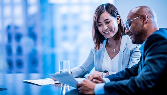 Business professionals discussing a project plan in a meeting room.