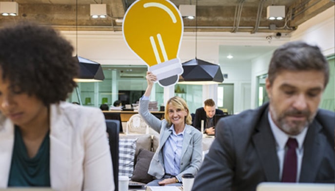 Lady holding a giant lightbulb over her head