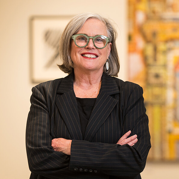 Executive director and exhibition curator Carey Mack Weber poses in the Walsh Gallery.