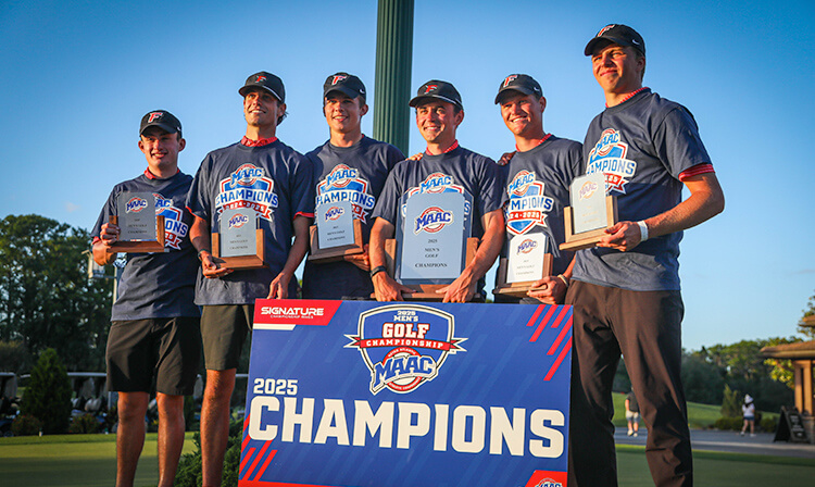 The men's golf team stands together, holding their trophies, celebrating their success and dedication to the game.
