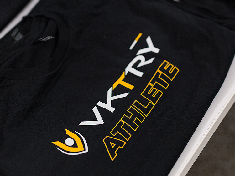Black T-shirt featuring "VKTRY ATHLETE" in bold white and yellow text, with a dynamic logo on the left.