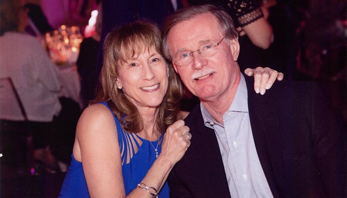 Robert Dawe with his wife Jean Dawe sitting at a table.