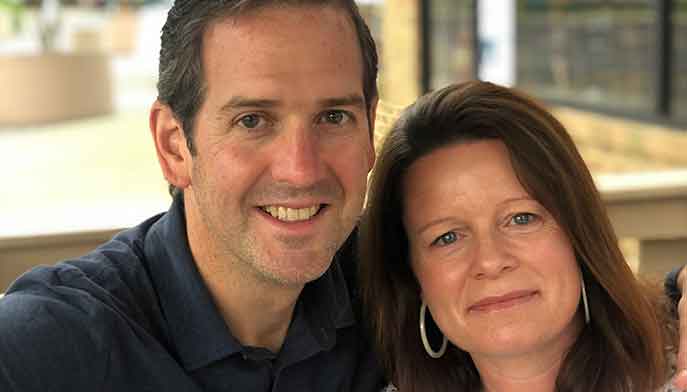 A photo of Josh and Michelle Brady shoulders touching.