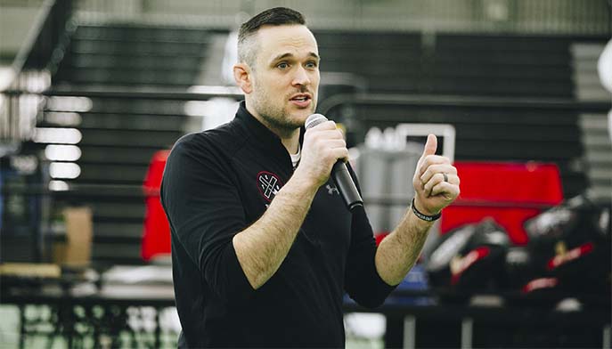 Image of Jon Thomas delivering an engaging speech at a jiu jitsu event