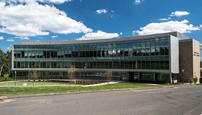 A large building featuring numerous windows, showcasing its expansive architecture and design.