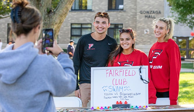 Fairfield Club Swim members smiling for a photo at the annual Activities Fair.