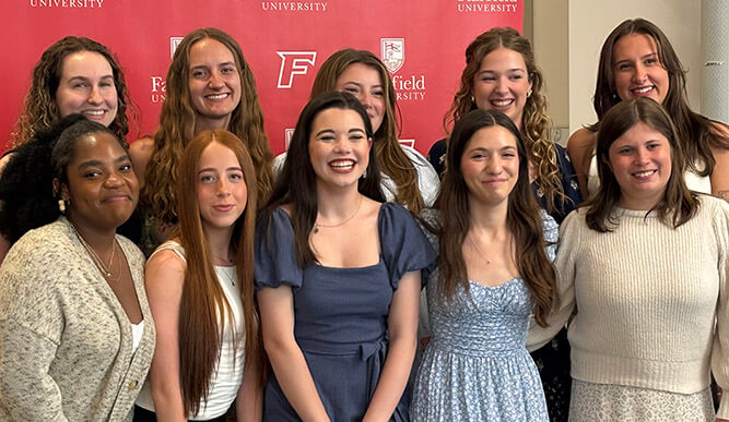 Members of the Triota National Women's and Gender Studies Honor Society posing as a group at their induction ceremony.